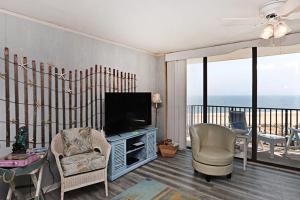 a living room with a television and a balcony at Sea Colony - 709 Brandywine House Rd in Bethany Beach +39 photos