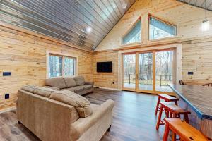 a living room with a couch and a table at Black Bear Cabin in Tomahawk