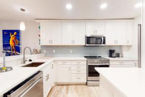 a white kitchen with a sink and a microwave at Sea Colony - 2D Brandywine Garden House Rd in Bethany Beach