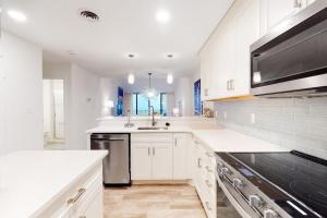 a white kitchen with a sink and a microwave at Sea Colony - 2D Brandywine Garden House Rd in Bethany Beach +27 photos