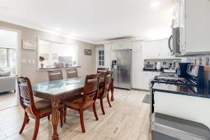 a kitchen with a dining room table and chairs at 112 Loganberry Lane in Rehoboth Beach