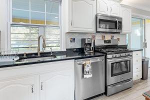 a kitchen with stainless steel appliances and white cabinets at 112 Loganberry Lane in Rehoboth Beach