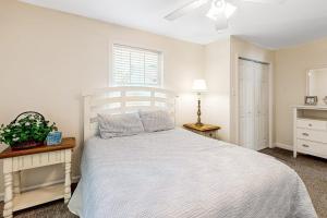 a bedroom with a white bed and a window at 112 Loganberry Lane in Rehoboth Beach