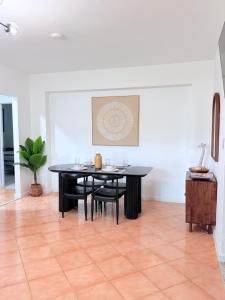 a dining room with a black table and chairs at Las Palmas in Biscayne Seaplane Base