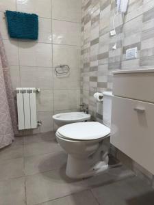 a bathroom with a toilet and a sink at Bienestar Studio in Bahía Blanca +17 photos