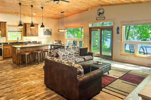a large living room with a couch and a kitchen at Pair-a-Docks Landing in Minocqua