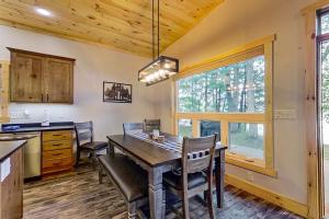 a kitchen and dining room with a table and chairs at Pair-a-Docks Landing in Minocqua