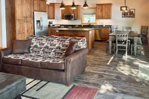 a living room with a couch and a kitchen at Pair-a-Docks Landing in Minocqua