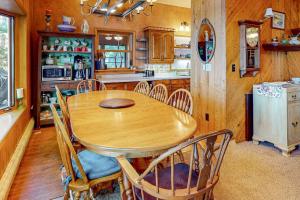 a dining room with a wooden table and chairs at Two Sisters Lakeside in Rhinelander