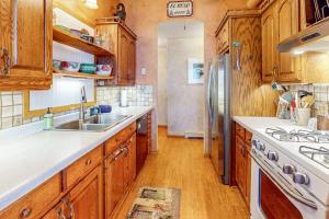 a kitchen with wooden cabinets and a stainless steel refrigerator at Two Sisters Lakeside in Rhinelander
