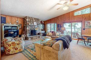 a living room with a couch and a fireplace at Two Sisters Lakeside in Rhinelander