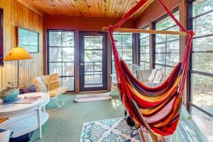 a room with a hammock in a house at Two Sisters Lakeside in Rhinelander +28 photos