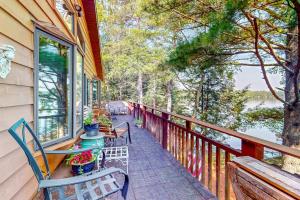 a balcony with chairs and tables on a house at Two Sisters Lakeside in Rhinelander