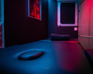 a room with a couch with a remote control on it at La Cachette Secrète - Maison romantique avec Balnéo et Sauna Privatif à Caen en Normandie in Caen