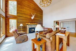 a living room with a couch and a fireplace at Pickerel Point Home in Saint Germain