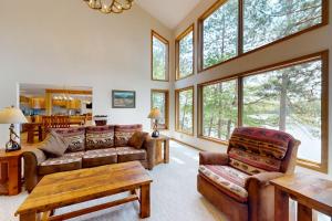 a living room filled with furniture and windows at Pickerel Point Home in Saint Germain +39 photos