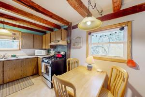 a kitchen with a wooden table and a dining room at Running Fox Farm in Baraboo