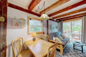 a dining room and living room with a wooden table and chairs at Running Fox Farm in Baraboo