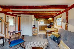 a living room with a couch and a kitchen at Running Fox Farm in Baraboo