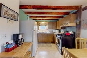 a small kitchen with a stove and a sink at Running Fox Farm in Baraboo +12 photos
