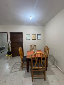a dining room with a wooden table and chairs at Departamento #10 in San Carlos +2 photos
