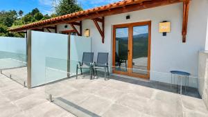 a balcony of a house with glass walls at Private Douro- Quinta das Susandas in Mesão Frio +108 photos