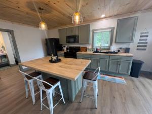 a kitchen with a large wooden table and chairs at The Hideaway at Wolf Creek in Nancy