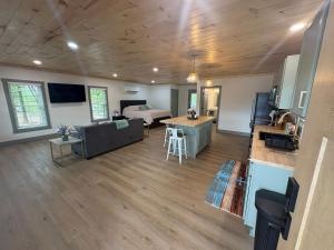 a living room and kitchen with a couch and a table at The Hideaway at Wolf Creek in Nancy +2 photos