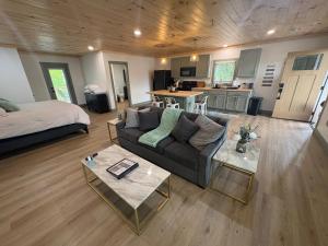 a living room with a couch and a kitchen at The Hideaway at Wolf Creek in Nancy