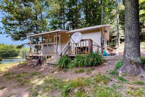 a tiny house in the woods next to a tree at Blue Jay Cabin in Rhinelander