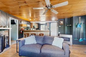 a living room with a couch and a ceiling fan at Blue Jay Cabin in Rhinelander