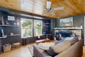 a living room with a couch and a fireplace at Blue Jay Cabin in Rhinelander