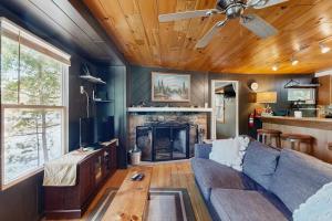 a living room with a couch and a fireplace at Blue Jay Cabin in Rhinelander