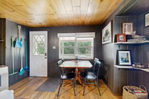 a dining room with a table and two chairs at Blue Jay Cabin in Rhinelander +12 photos