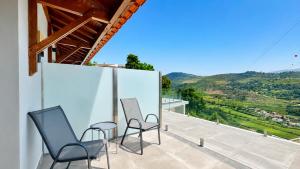 two chairs and a table on a balcony with a view at Private Douro- Quinta das Susandas in Mesão Frio