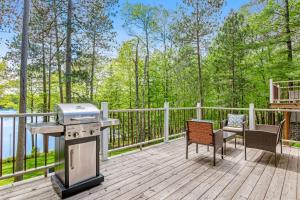 a grill on a deck with a table and chairs at Road Lake Escape in Tomahawk