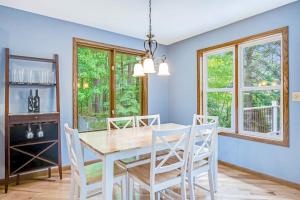 a dining room with a white table and chairs at Road Lake Escape in Tomahawk
