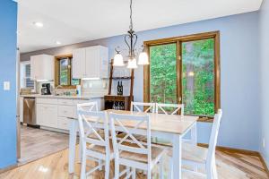 a kitchen with a dining room table and chairs at Road Lake Escape in Tomahawk