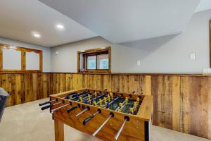 a ping pong table in a room with wooden walls at Dreams on the Lake in Tomahawk