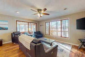 a living room with a couch and a ceiling fan at Dreams on the Lake in Tomahawk