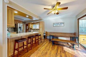 a kitchen with wooden floors and a ceiling fan at Dreams on the Lake in Tomahawk
