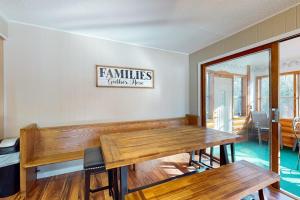 a dining room with a table and a sign on the wall at Dreams on the Lake in Tomahawk