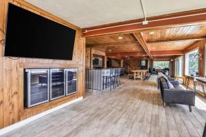 a living room with a flat screen tv on a wall at Timber Lodge Retreat in Rhinelander +42 photos