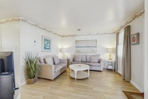 a living room with a couch and a table at 37534 Lighthouse Rd #202 in Fenwick Island