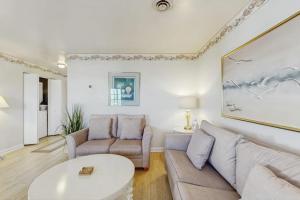a living room with a couch and a table at 37534 Lighthouse Rd #202 in Fenwick Island