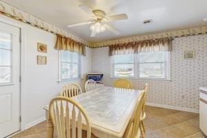 a dining room with a table and chairs and a ceiling fan at 37534 Lighthouse Rd #202 in Fenwick Island +14 photos