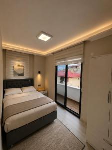 a bedroom with a bed and a large window at Trabzon Albayrak Suite in Trabzon