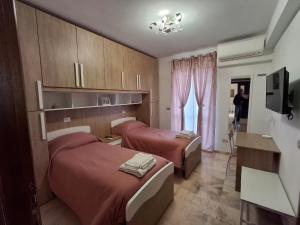 a hotel room with two beds and a window at Beautiful Dreams in San Giorgio a Liri