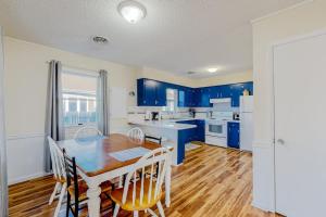 a kitchen with blue cabinets and a table and chairs at Rehoboth Beach Anna B St in Rehoboth Beach