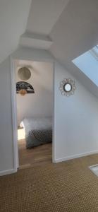 a room with a bedroom with a bed and a ceiling at quiet house in Nogent-sur-Eure